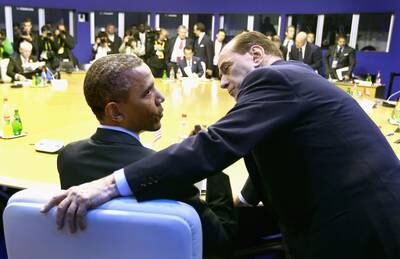 US President Barack Obama talks to Berlusconi as they attend the G8 summit in 2011 in Deauville, France. Getty