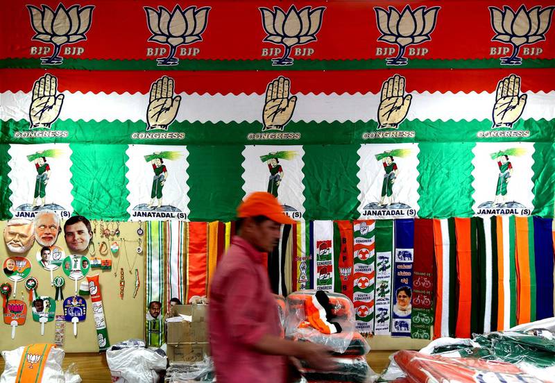 A shopkeeper arranges election campaign items for sale in Bangalore. EPA