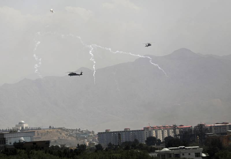 US military helicopters drop decoy flares while flying over the Afghan capital of Kabul. Photo: AP