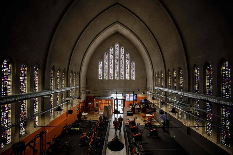 Gym members train at a sports hall that opened in an old disused chapel, in Caen, northwestern France. AFP