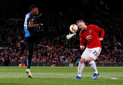 Manchester United's Luke Shaw takes on Club Brugge's David Okereke. Reuters