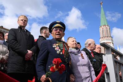 Veterans and guests watch the Victory Day military parade at Red Square in central Moscow. AFP