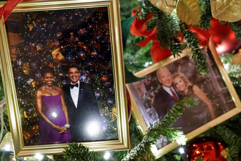 Christmas trees in the State Dining Room are decorated with snapshots of US presidents and their families. This photo shows the Obamas and Bidens. Reuters