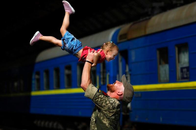 Ukrainian soldier Oleksandr with his daughter Nikole at Lviv railway station in August 2022. Getty Images