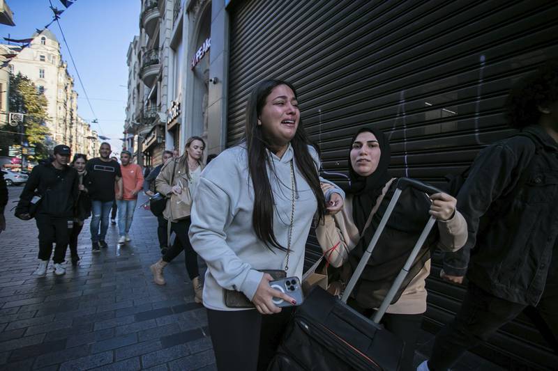 People leave the area after an explosion on Istanbul's popular pedestrian Istiklal Avenue Sunday. AP
