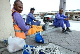Workers rest under the shade behind the Dates Market at Mina Zayed in Abu Dhabi in 2021. Victor Besa / The National