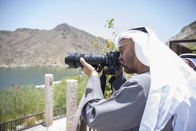 The President, Sheikh Mohamed, takes photos during a visit to Al Dhaid and Khor Fakkan in Sharjah. He was pictured greeting  families during a weekend tour of Dubai and the Northern Emirates. Hamad Al Kaabi / Ministry of Presidential Affairs 