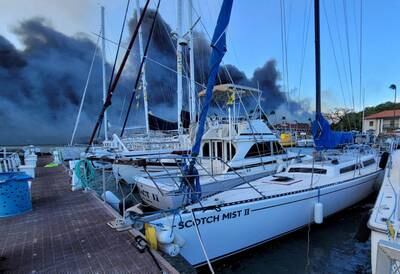 Boats docked at Lahaina as smoke streams from wildfires in the Hawaii town in Maui. Reuters
