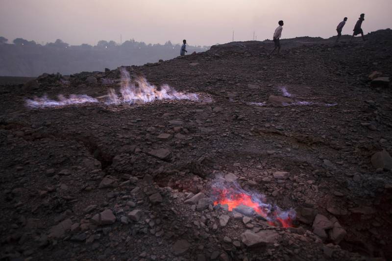 JHARKHAND, INDIA - DECEMBER 06: Flames rise from an underground coal seam fire in Bokapahari in Dhanbad, Jharkhand, India on December  6, 2014. Underground fires are a major threat of subsidence for nearly 100,000 families in Dhanbad. Indian government lead by Prime Minister Narendra Modi plans to double its coal production by 2019.
(Photo by Kuni Takahashi/Getty Images)
