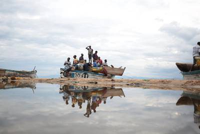 Fishermen board a boat in readiness of a long night of fishing on Lake Malawi’s shore about 200km out of the commercial capital Blantyre, Malawi. Many people earn their living by either catching or selling fish from the lake. Aaron Ufumeli / EPA