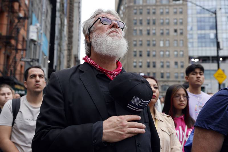 Edward Young observes a moment of silence as people gather on Cedar Street by the perimeter of the commemoration ceremony in New York. AP Photo