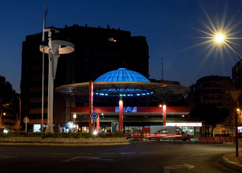 This photograph taken in Alcala de Henares, near Madrid, Spain, shows a petrol station at night, past a statue of Spanish writer Miguel de Cervantes's famous character Don Quixote de la Mancha, and a roof designed as his knight-errant's helmet.
