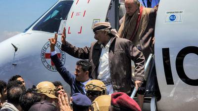 Mahmoud Al Subaihi, centre, former defence minister of Yemen's internationally recognised government, and Nasser Mansur Hadi, top, brother to former Yemeni president Abdrabbuh Mansur Hadi, arrive at Aden International Airport after being freed by the Houth rebels under the prisoner exchange deal. AFP