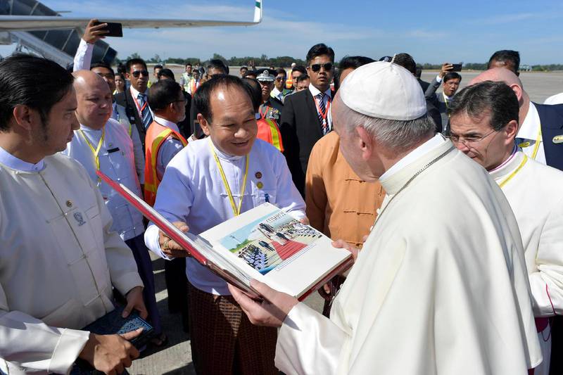 Pope Francis receives a gift as he prepares to depart for Dhaka. Osservatore Romano / Handout via Reuters