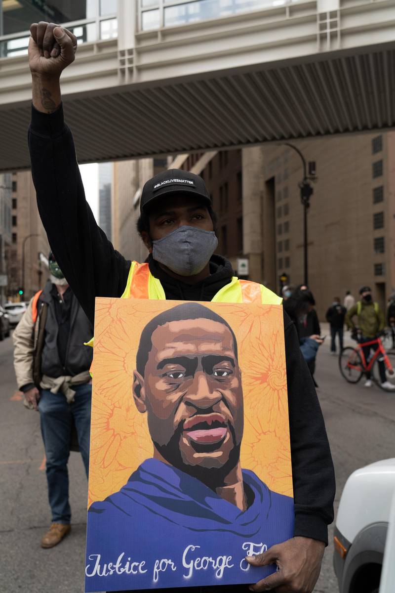A man holds a portrait of George Floyd outside the Hennepin County Government Centre. Willy Lowry / The National