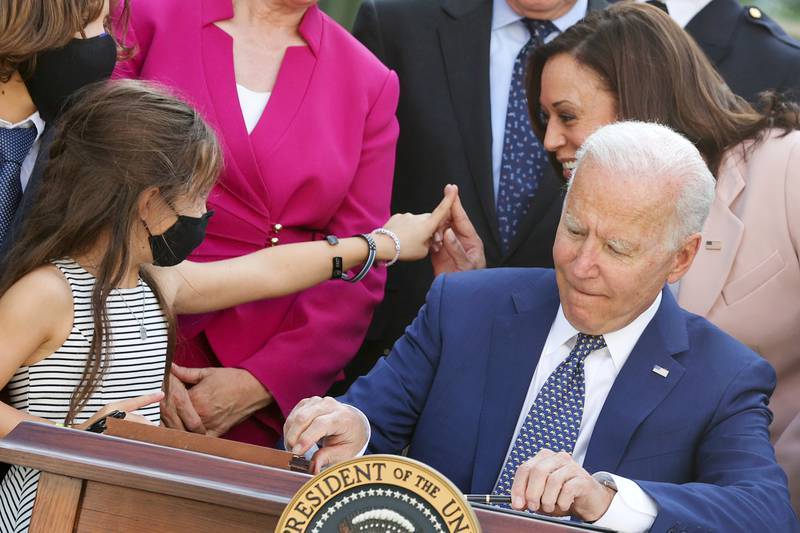 Kamala Harris‬ and Joe Biden interact with family members of fallen police officers as Mr Biden signs into law an act to award four Congressional Gold Medals to the US Capitol Police, Washington Metro Police and those who protected the Capitol on January 6. Reuters