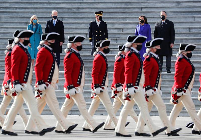 US President Joe Biden, first lady Jill Biden, Vice President Kamala Harris, and her husband Doug Emhoff look on as they leave the US Capitol after the inauguration ceremony. Reuters