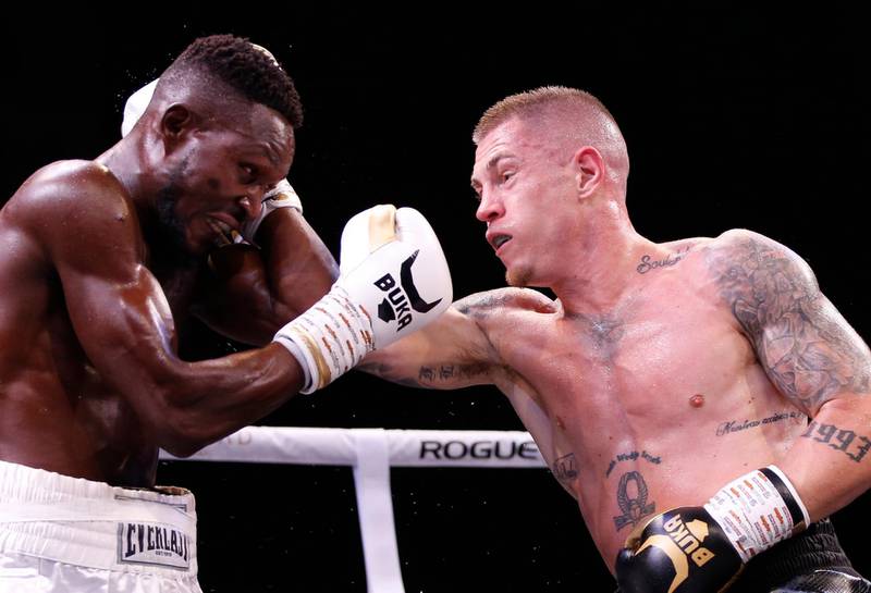 Anthony de Bruijn, right, of the Netherlands catches Emmanuel Noi Mensah of Ghana during their bout in Dubai. EPA