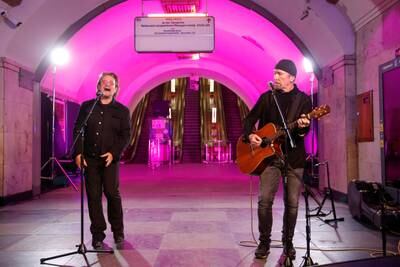 Bono and The Edge sing during a performance for Ukrainian people inside a subway station in Kyiv on May 8. Reuters