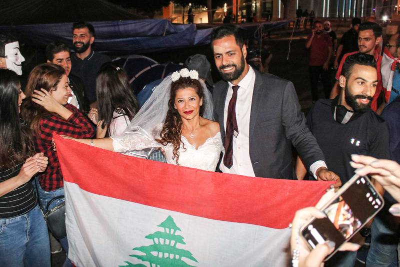 Malak Alaywe Herz, a woman who famously kicked the bodyguard of Education Minister Akram Chehayeb and became an icon in the current anti-government protests, poses for a picture in her wedding dress.  AFP