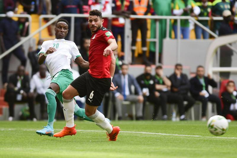 Senegal's Bouna Sarr passes the ball under pressure from Yasser Ibrahim of Egypt. AFP