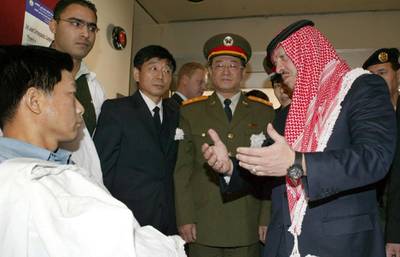 King Abdullah visits a wounded Chinese citizen at a hospital in Amman in November 2005. Three Chinese were killed and one wounded in suicide attacks in the city. AFP