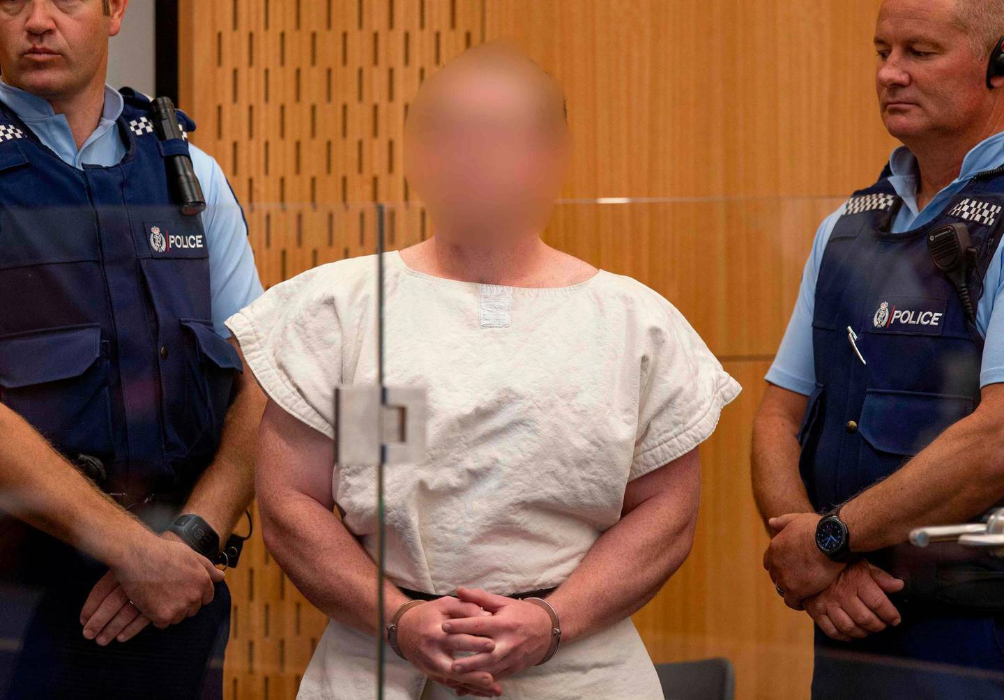 Brenton Tarrant, the man charged in relation to the Christchurch massacre appear in the dock charged with murder in the Christchurch District Court on March 16, 2019.
 A right-wing extremist who filmed himself rampaging through two mosques in the quiet New Zealand city of Christchurch killing 49 worshippers appeared in court on a murder charge March 16, 2019. Australian-born 28-year-old Brenton Tarrant appeared in the dock wearing handcuffs and a white prison shirt, sitting impassively as the judge read a single murder charge against him. A raft of further charges are expected. - --EDS NOTE HIS FACE MUST BE PIXELATED..ONLY HIS FACE--
 
 / AFP / POOL / Mark Mitchell / --EDS NOTE HIS FACE MUST BE PIXELATED..ONLY HIS FACE--
 
