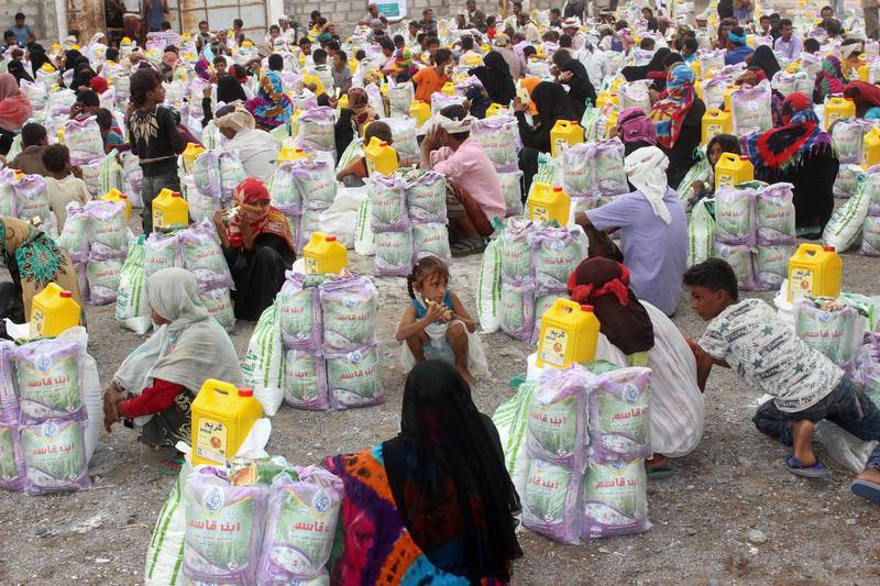 Displaced Yemenis from Durahemi receive food aid in the Red Sea port city of Hodeida on August 9, 2019. The Yemeni conflict has triggered what the United Nations describes as the world's worst humanitarian crisis, with 3.3 million people still displaced and 24.1 million in need of aid. / AFP / -

