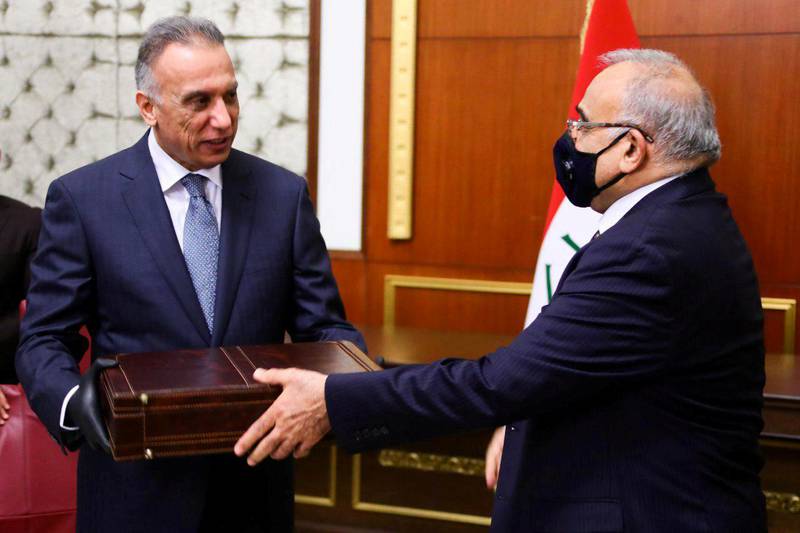 Former Iraqi Prime Minister Adel Abdul Mahdi hands over to new Prime Minister Mustafa al-Kadhimi in Baghdad, Iraq, May 7, 2020. Picture taken May 7, 2020. Iraqi Parliament Media Office/Handout via REUTERS ATTENTION EDITORS - THIS PICTURE WAS PROVIDED BY A THIRD PARTY.