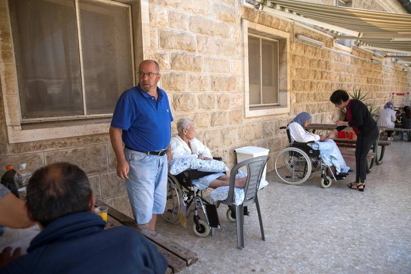 Family members with their hospitalised family members from  the palliative department on a terrace of the Augusta Victoria Hospital on the Mt. of Olives in east Jerusalem on September 12,2018.

Last Friday the Trump administration announced cutting aid to Palestinians that slashes funds for cancer patients and others in critical need being treated in the East Jerusalem network of hospitals. The State Department said it was slashing $25 million . US President Donald Trump said that he is pressuring the Palestinians to negotiate a peace deal with Israel .(Photo by Heidi Levine For The National).