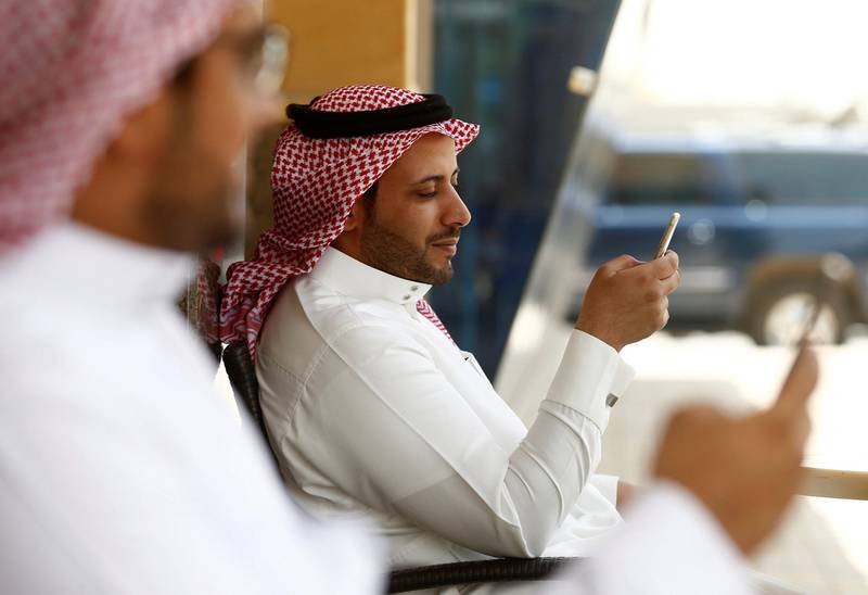 Saudi men explore social media on their mobile devices as they sit at a cafe in Riyadh. Faisal Al Nasser / Reuters 