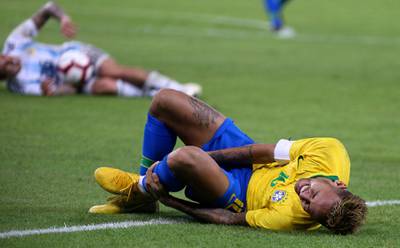 Neymar lies on the pitch during the friendly match at the King Abdullah Sport City Stadium. AFP