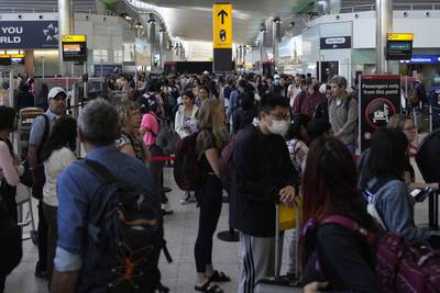 Travellers queue at London's Heathrow. Travel demand is back with a vengeance but having slashed jobs during the pandemic the industry is struggling to keep up. AP