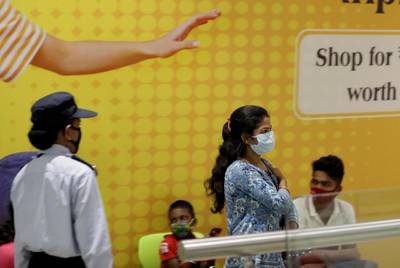 A woman leaves after receiving a vaccine shot during a vaccination drive at a shopping mall in Kolkata, India. Medica Superspecialty Hospital and Hindustan Club jointly start the vaccination drive.  EPA