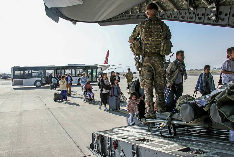 British and dual citizens living in Afghanistan board a military plane at Kabul airport. Reuters