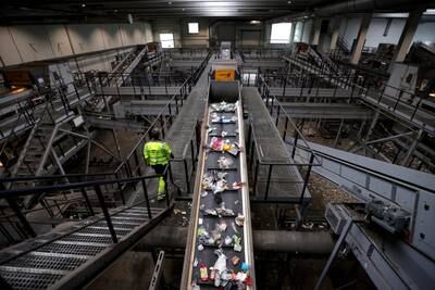A worker checks the plastic waste at the Interzero recycling plant in Marl, Germany.  EPA 