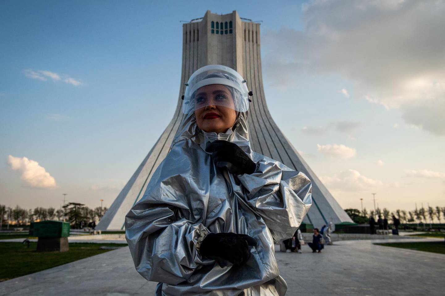 A volunteer wearing protective personal equipment (PPE) takes part in disinfecting operations on Azadi Square in Tehran, Iran, on Friday, March 27, 2020. Iranian President Hassan Rouhani said on Saturday that the government has allocated an additional 100 trillion tomans to address the spread the coronavirus in the country. Photographer: Ali Mohammadi/Bloomberg