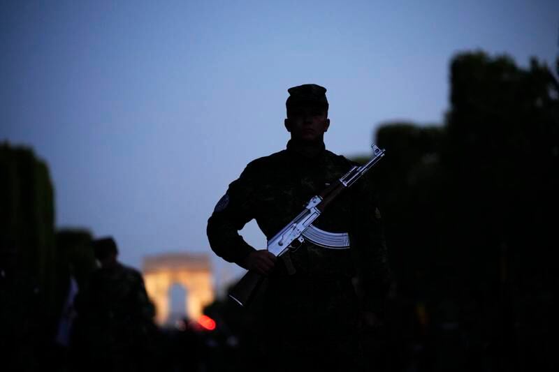 Soldiers stand on the Champs Elysees during a rehearsal for the Bastille Day parade in Paris. AP
