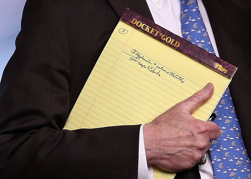 Mr Bolton set off alarm bells when he was spotted holding a legal pad with the words 5,000 troops to Colombia scribbled on it. Getty