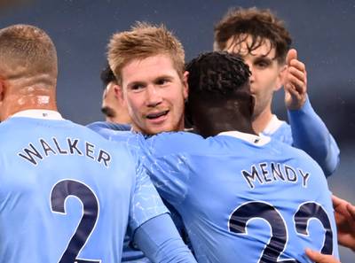 Manchester City's French defender Benjamin Mendy (3rd R) celebrates with Manchester City's Belgian midfielder Kevin De Bruyne (2nd L) and teammates after scoring their third goal during the English Premier League football match between Manchester City and Burnley at the Etihad Stadium in Manchester, north west England, on November 28, 2020. (Photo by Laurence Griffiths / POOL / AFP) / RESTRICTED TO EDITORIAL USE. No use with unauthorized audio, video, data, fixture lists, club/league logos or 'live' services. Online in-match use limited to 120 images. An additional 40 images may be used in extra time. No video emulation. Social media in-match use limited to 120 images. An additional 40 images may be used in extra time. No use in betting publications, games or single club/league/player publications. /