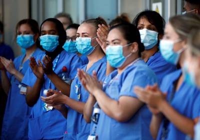 NHS workers react at the Royal London Hospital during the last day of the Clap for our Carers campaign in support of the NHS, following the outbreak of the coronavirus disease (COVID-19), London, Britain, May 28, 2020. REUTERS/Henry Nicholls     TPX IMAGES OF THE DAY