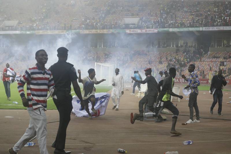 Police fire tear gas at Nigeria after the match. AP