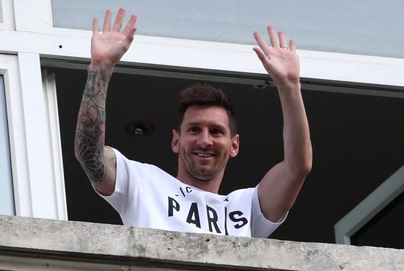 Lionel Messi waves to supporters.