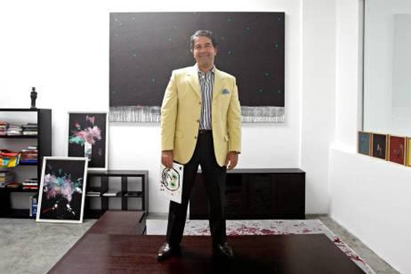 Al Quoz - November 10, 2011- Ramin Salsali, founder of the SPM Private Museum, holding a painting by his ten-year-old son Douglas titled "Papi" in his office at the museum in Al Quoz 1, Dubai, November 10, 2011. (Photo by Jeff Topping/The National) 

 