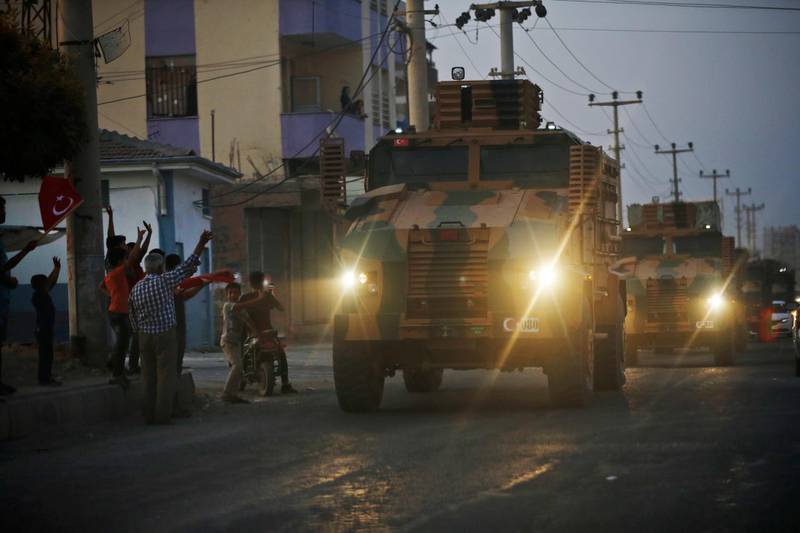 A convoy of Turkish forces vehicles moves through the town of Akcakale, Sanliurfa province, southeastern Turkey, at the border between Turkey and Syria. AP Photo