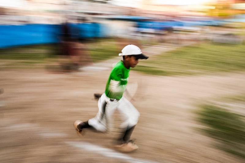 A boy runs during a baseball training class in Havana. The 2023 World Baseball Classic begins on March 7.  AFP