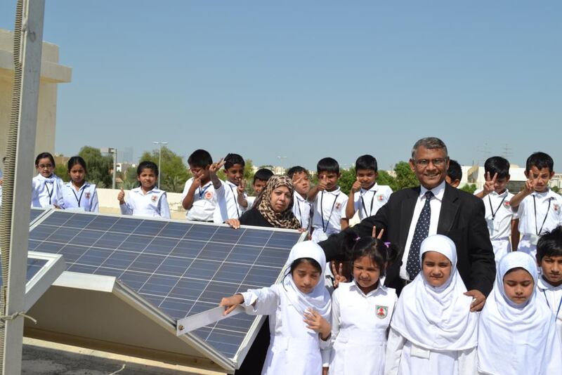 Principal Mir Anisul Hasan alongside the solar panels installed
with prize money from the Zayed Future Energy Prize. Photo: Zayed Future Energy Prize