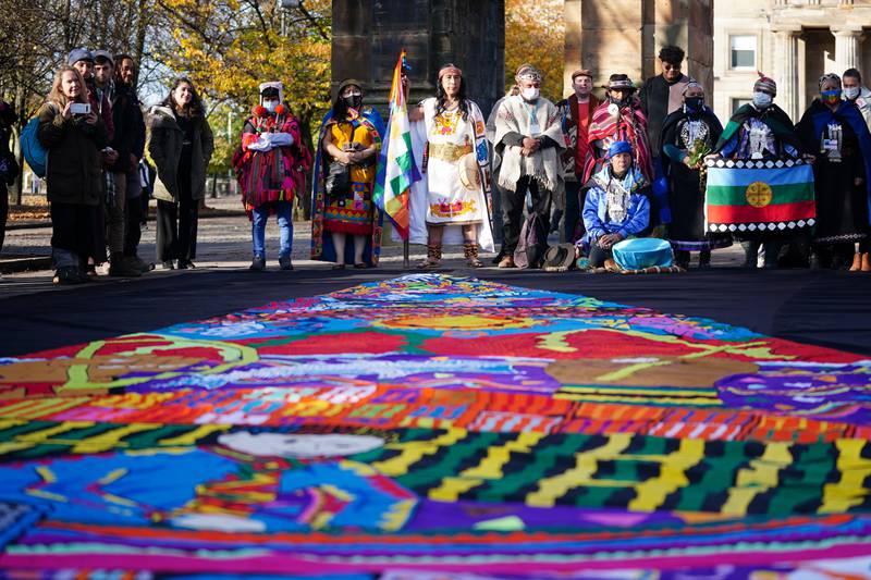 Indigenous leaders in ceremonial dress gather at the McLennan Arch in Glasgow Green to march to the Scottish Event Campus in Glasgow, announcing their arrival at the Cop26 summit. PA