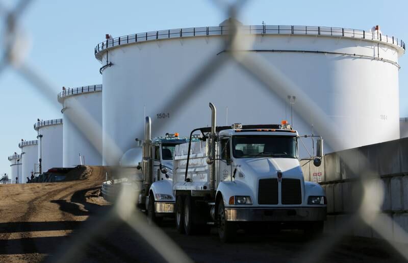 FILE PHOTO: Dump trucks are parked near crude oil tanks at Kinder Morgan's North 40 terminal expansion construction project in Sherwood Park, near Edmonton, Alberta, Canada November 13, 2016.  REUTERS/Chris Helgren/File Photo