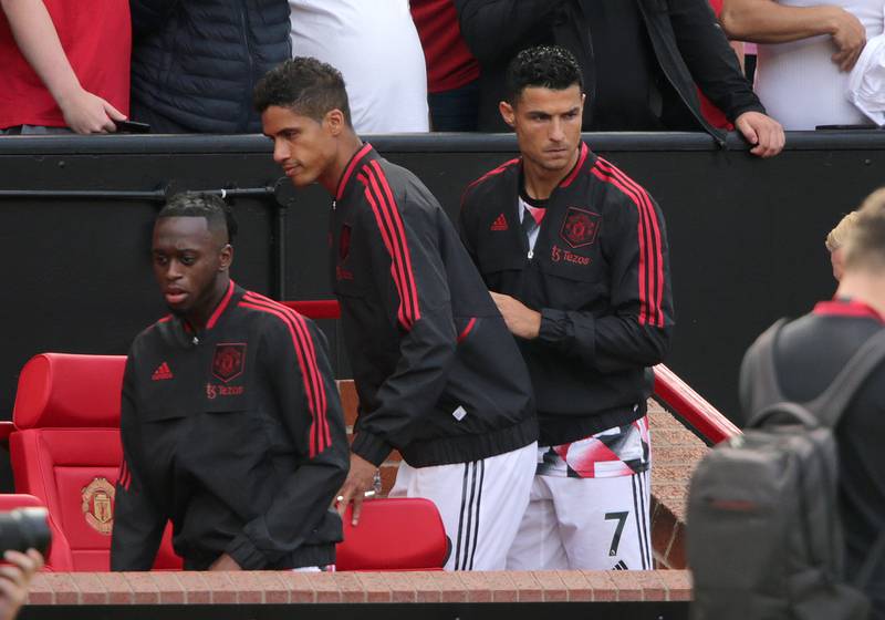 Manchester United's Cristiano Ronaldo, right, takes his seat on the bench. PA
